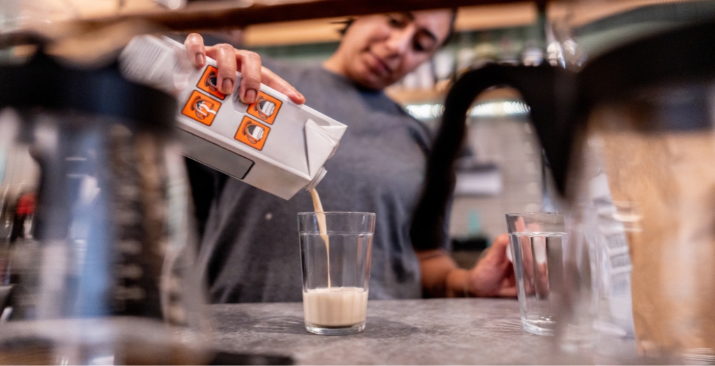Do milk dispensers for coffee shops work with oat milk? 4 Barista measuring oat milk by eye instead of using milk dispensers for coffee shops